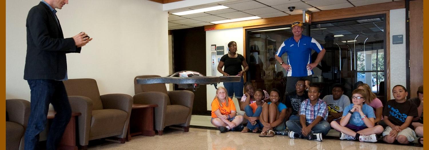 Students observing a drone demonstration